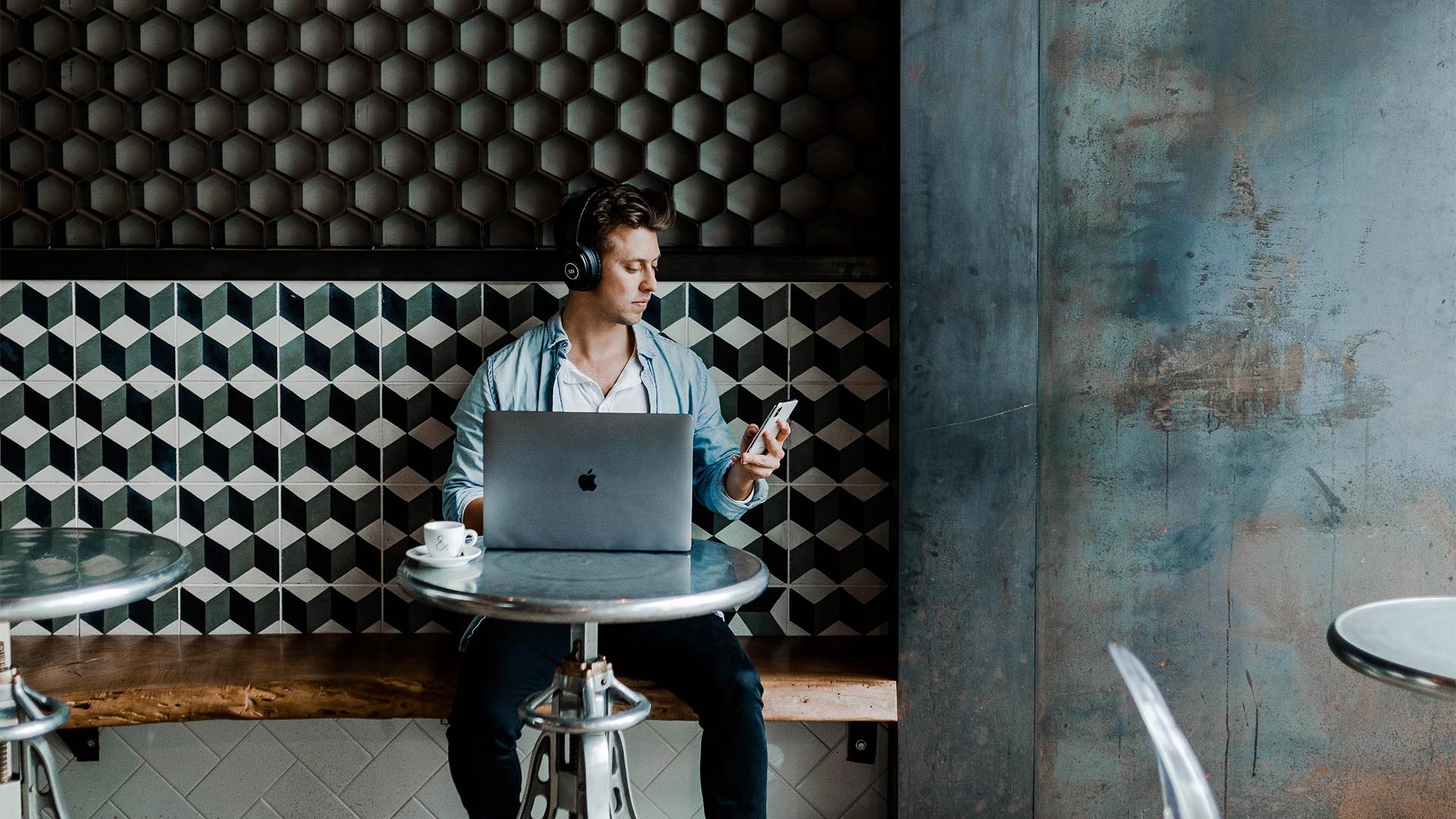 Person working on laptop at cafe.