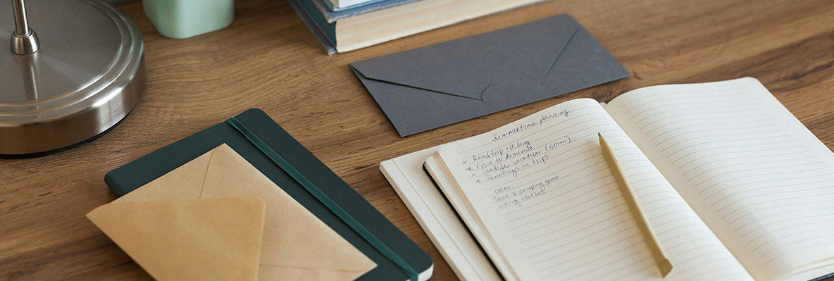 Wood desk with stationery supplies.
